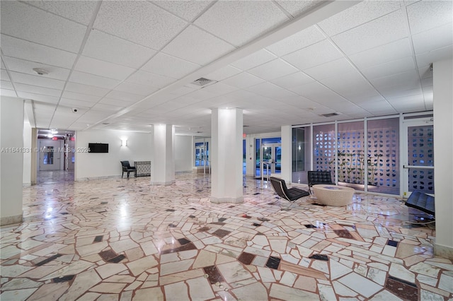 basement featuring tile patterned floors and a drop ceiling