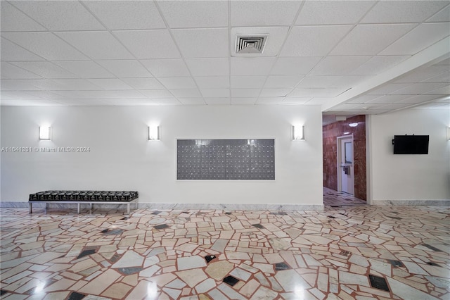 basement featuring a paneled ceiling