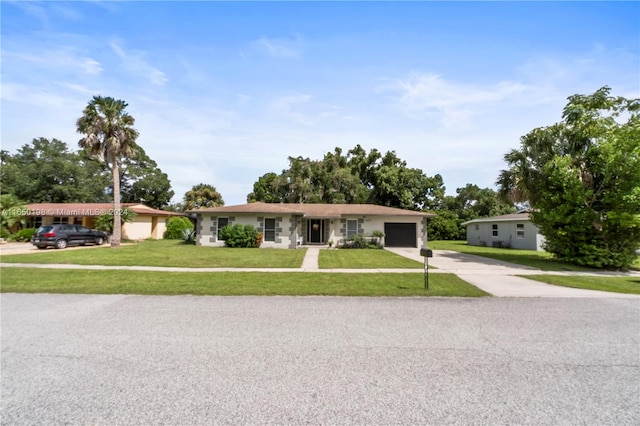 ranch-style house with a garage and a front lawn