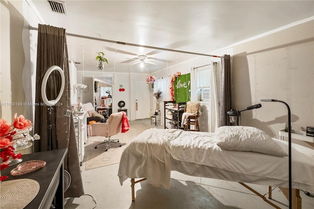 bedroom with ceiling fan and concrete flooring