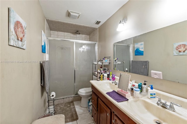 bathroom with vanity, toilet, an enclosed shower, and tile patterned floors