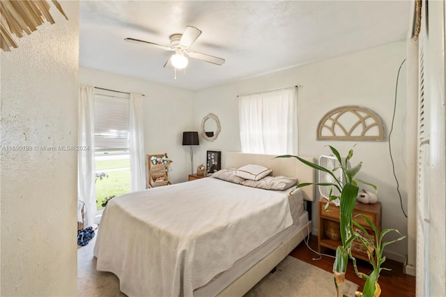 bedroom with hardwood / wood-style flooring and ceiling fan