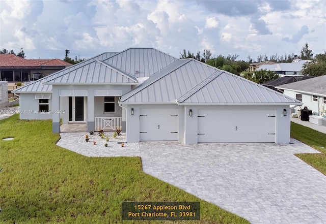 rear view of house with a yard and a garage