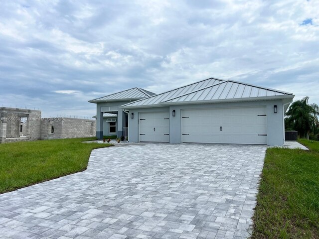 view of front of property with a garage and a front lawn