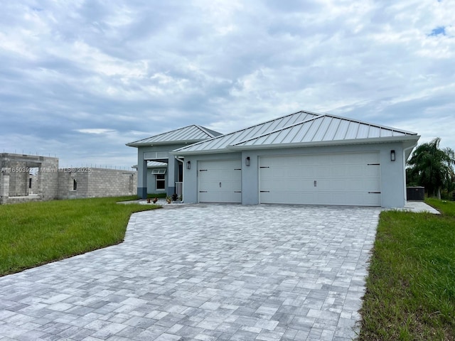 view of front of home featuring a garage and a front lawn