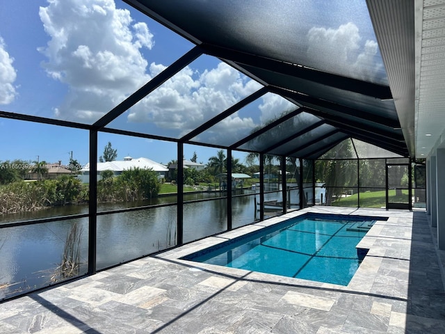 view of swimming pool with a water view, a patio area, and a lanai