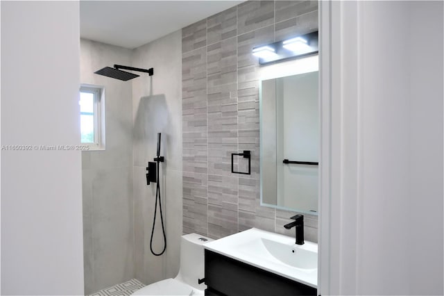 bathroom featuring tile walls, backsplash, tiled shower, vanity, and toilet