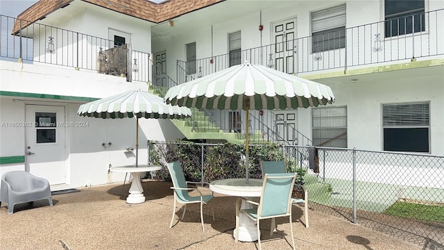 view of patio featuring a balcony