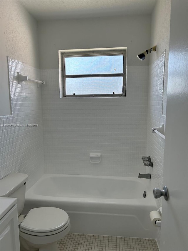 full bathroom with vanity, toilet, tile patterned floors, and tiled shower / bath