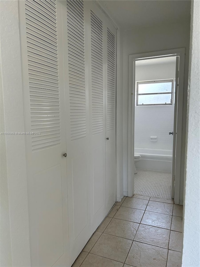 corridor featuring light tile patterned floors