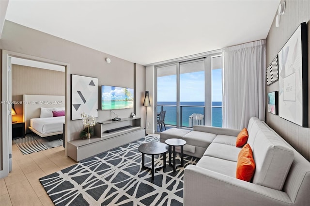 living room featuring floor to ceiling windows and light hardwood / wood-style flooring