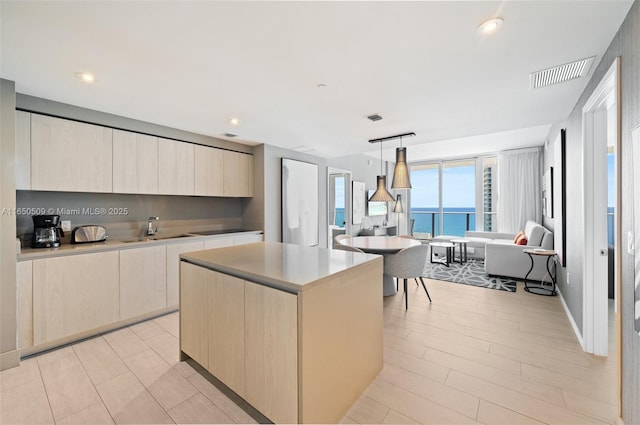 4010 S Ocean Dr Unit T3507, Hollywood, FL 33019 - kitchen with a sink, modern cabinets, light brown cabinets, light countertops, and a kitchen island