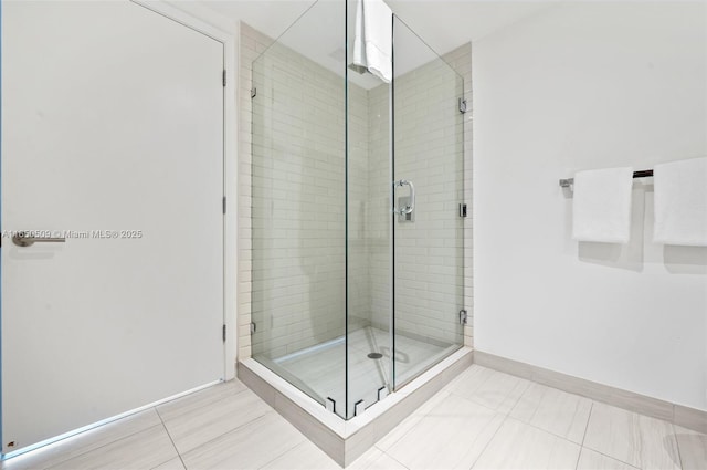 bathroom with tile patterned floors and a shower with shower door