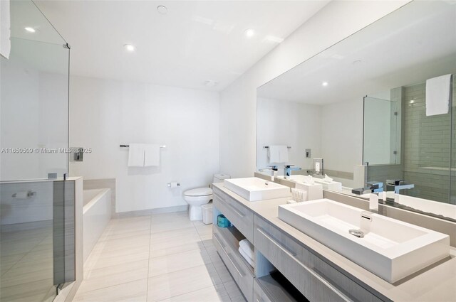 full bathroom with vanity, tile patterned floors, plus walk in shower, and toilet