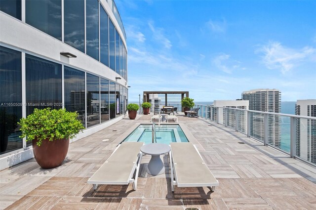 view of swimming pool featuring a pergola, a patio area, and a water view