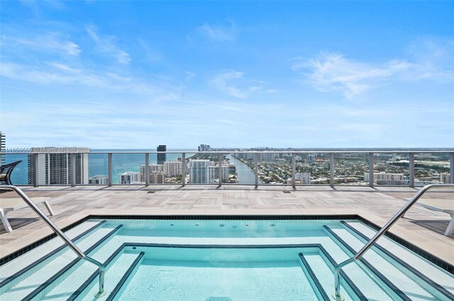 view of pool featuring a water view