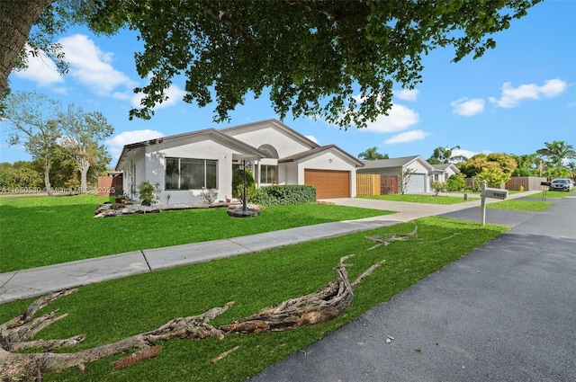 ranch-style home with a front yard and a garage