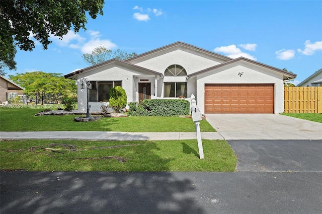 ranch-style house featuring a garage and a front lawn