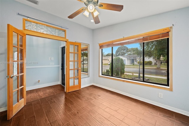 unfurnished room featuring ceiling fan and french doors