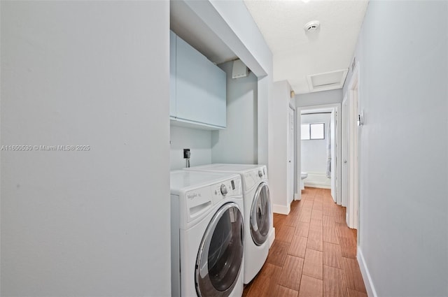 laundry area with a textured ceiling and washer and clothes dryer