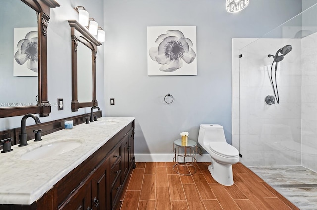 bathroom featuring tiled shower, vanity, and toilet