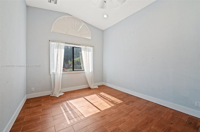 empty room featuring vaulted ceiling