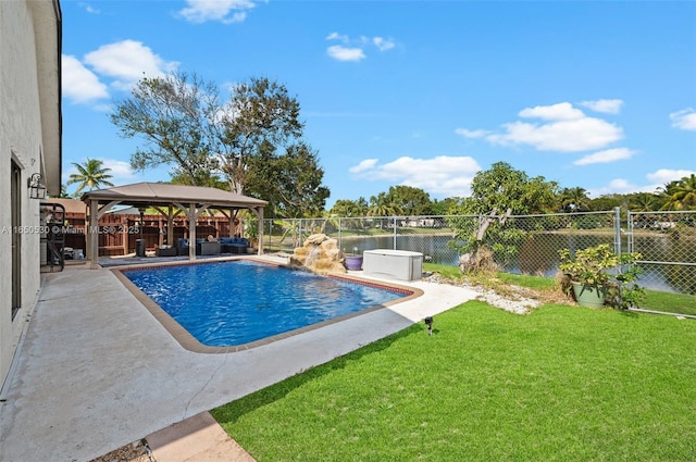 view of swimming pool featuring a patio area, a yard, a gazebo, pool water feature, and a water view