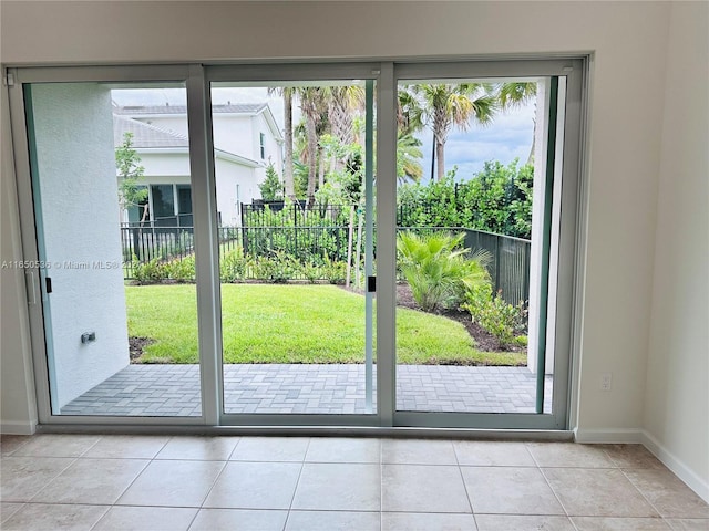 doorway featuring a healthy amount of sunlight and light tile patterned floors