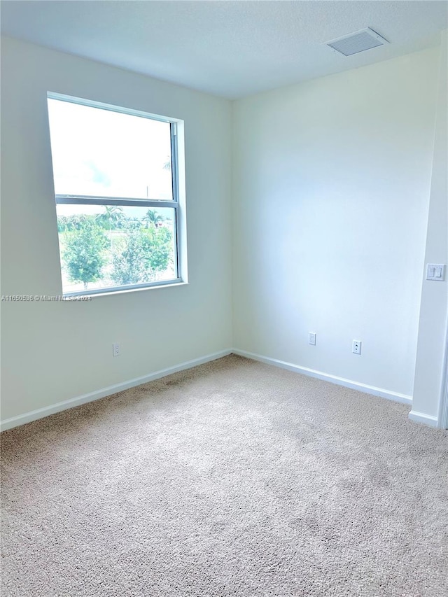 spare room featuring carpet