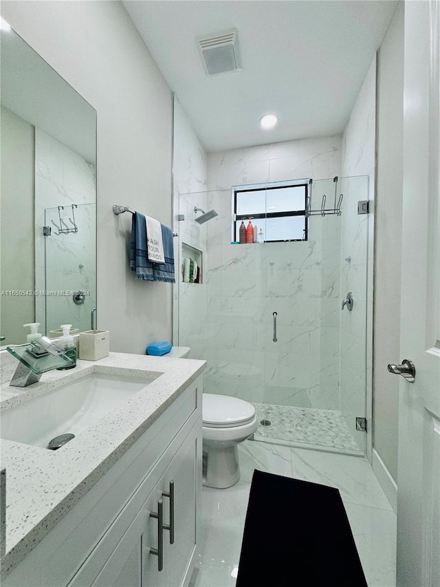 bathroom with vanity, toilet, and an enclosed shower