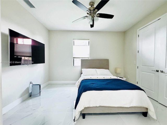 bedroom featuring ceiling fan and a closet