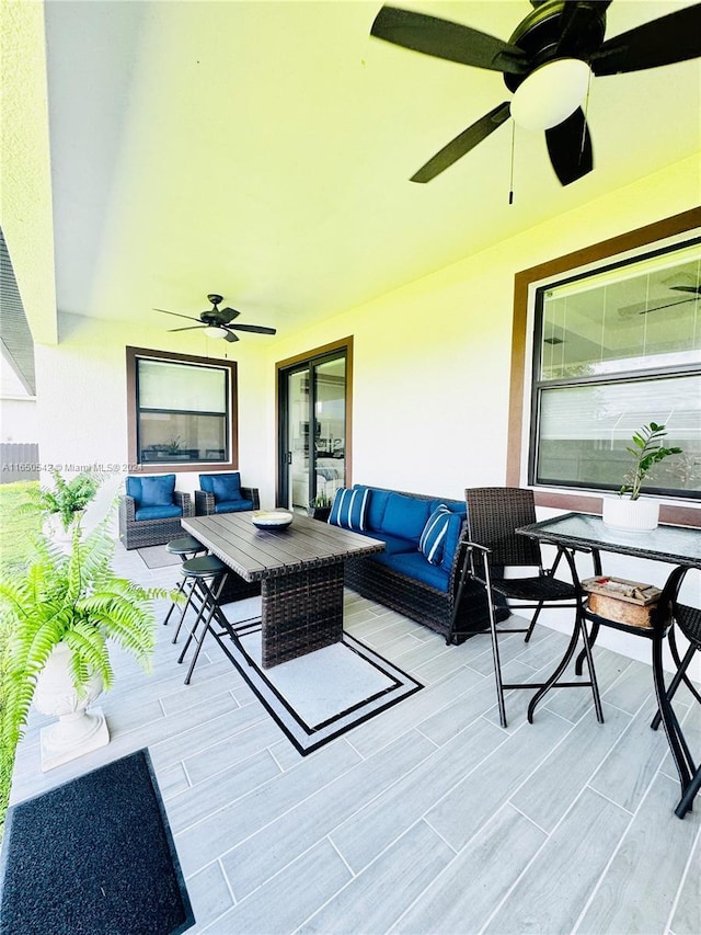 view of patio / terrace with an outdoor living space with a fireplace