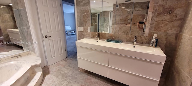 bathroom featuring tile walls, a shower with shower door, and vanity