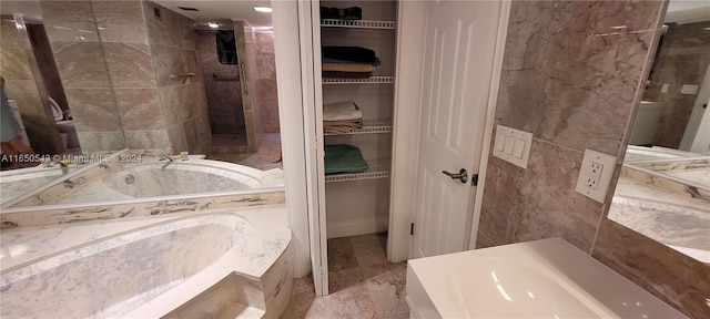 bathroom featuring separate shower and tub