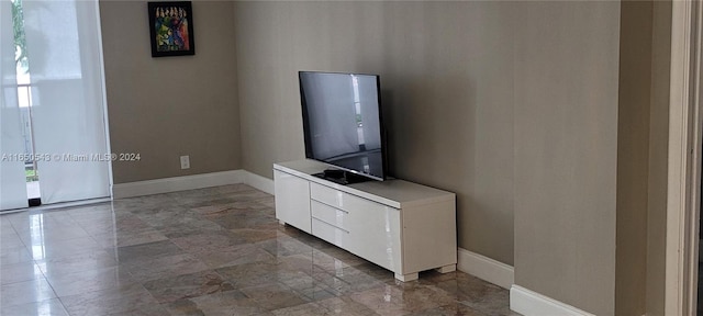 unfurnished living room featuring a wealth of natural light