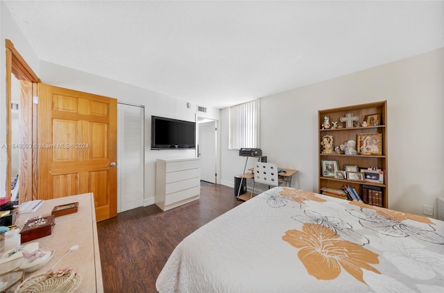 bedroom with a closet and dark hardwood / wood-style floors