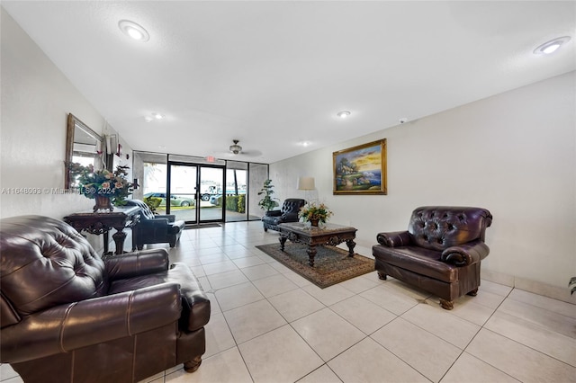 tiled living room featuring a wall of windows and ceiling fan