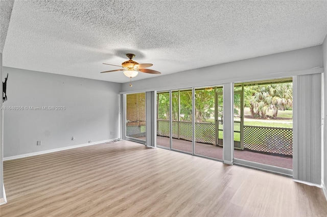 8145 Lagos De Campo Blvd Unit D-1, Tamarac, FL 33321 - spare room with wood finished floors, ceiling fan, healthy amount of natural light, and a textured ceiling