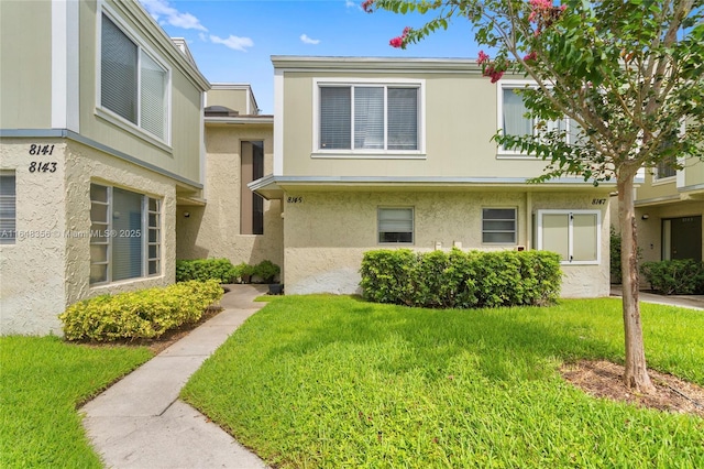 8145 Lagos De Campo Blvd Unit D-1, Tamarac, FL 33321 - view of property featuring a front lawn and stucco siding