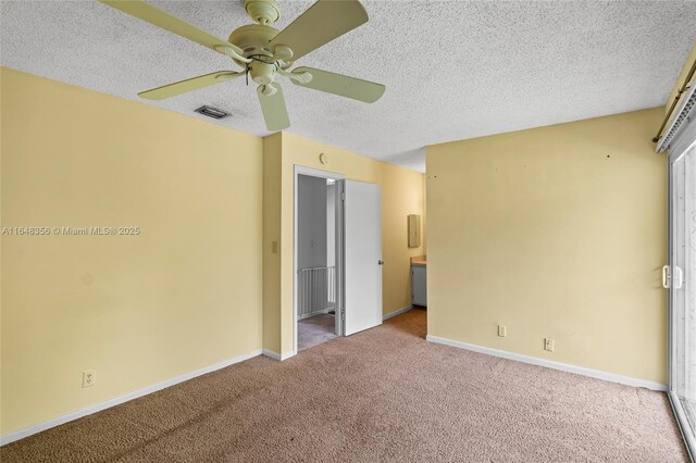 unfurnished room featuring ceiling fan, a textured ceiling, and carpet floors