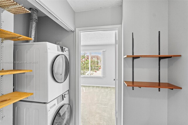 washroom with a textured ceiling, carpet flooring, and stacked washer / dryer