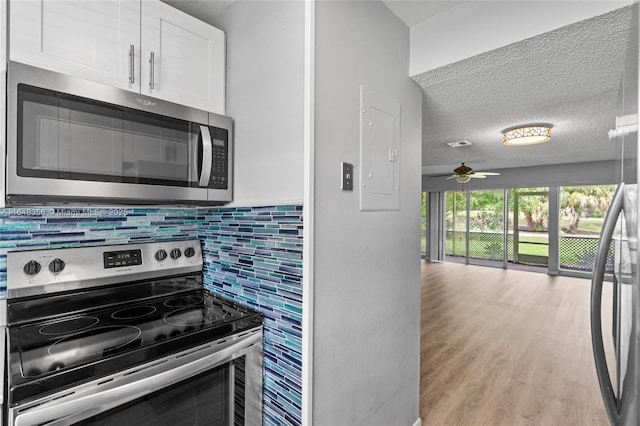 8145 Lagos De Campo Blvd Unit D-1, Tamarac, FL 33321 - kitchen with appliances with stainless steel finishes, electric panel, white cabinets, backsplash, and a ceiling fan
