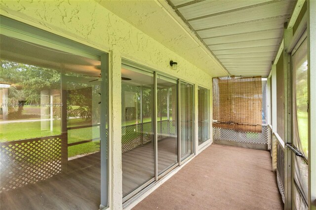 rear view of house with a balcony and a yard