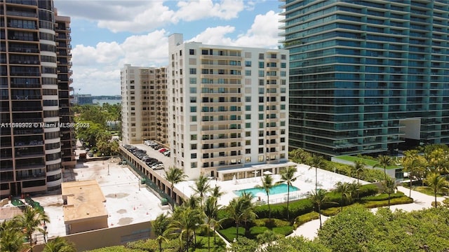 view of building exterior featuring a community pool