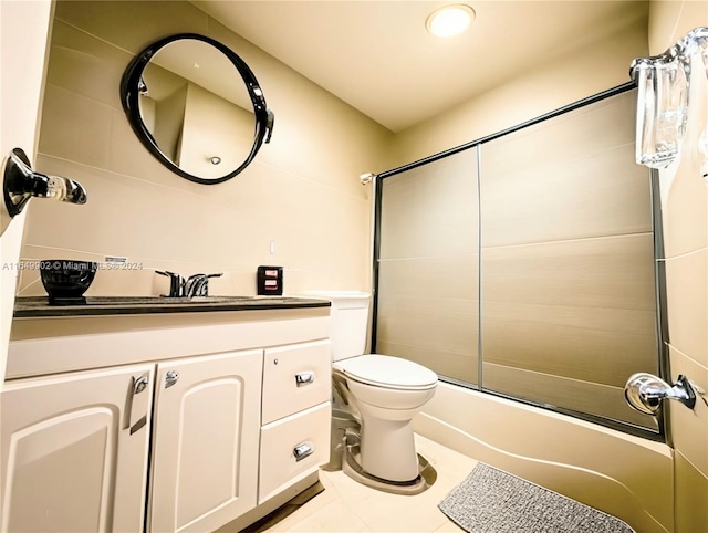 full bathroom with tile patterned floors, enclosed tub / shower combo, toilet, and vanity