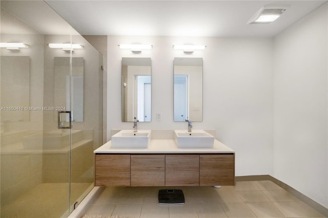 bathroom featuring tile patterned flooring, vanity, and walk in shower