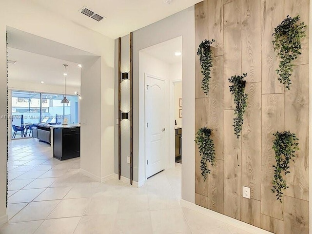 hall with light tile patterned flooring