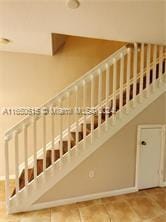 staircase featuring tile patterned floors