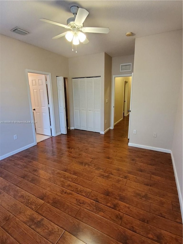 unfurnished bedroom featuring dark hardwood / wood-style flooring and ceiling fan