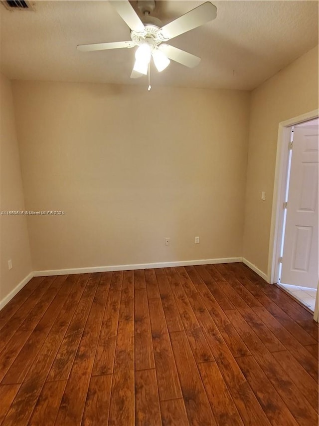 unfurnished room featuring dark hardwood / wood-style flooring and ceiling fan